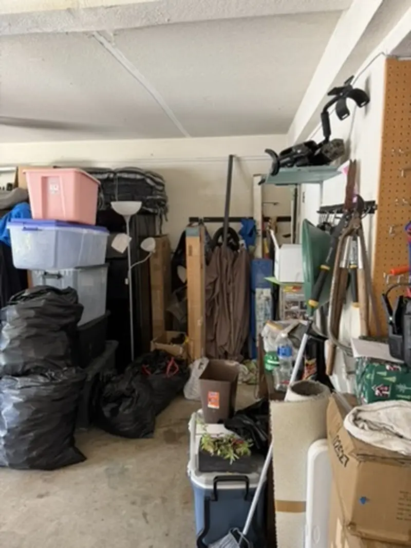 Cluttered garage in property purchased as-is